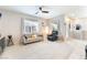 Inviting living room with neutral décor, carpet floors, lots of natural light, and ceiling fan at 2860 Sunflower Days Ave # 2141, North Las Vegas, NV 89031