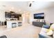 Living room showcases open layout with a large tv, modern furnishings, and bright kitchen nearby at 2860 Sunflower Days Ave # 2141, North Las Vegas, NV 89031
