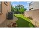 A stunning backyard features artificial turf, a putting green, and low-maintenance desert landscaping at 2862 Athens Ridge Dr, Henderson, NV 89052