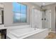 Bright bathroom featuring a soaking tub and walk-in shower with glass enclosure at 2862 Athens Ridge Dr, Henderson, NV 89052