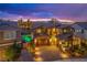 Aerial view of a landscaped home with a pool and extended driveway, set against a dramatic evening sky at 2862 Athens Ridge Dr, Henderson, NV 89052