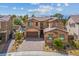 An aerial view of a two-story home with a three-car garage, a brick driveway and desert landscaping at 2862 Athens Ridge Dr, Henderson, NV 89052