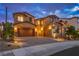 Striking two-story home featuring a stylish facade and a well-manicured desert landscape at 2862 Athens Ridge Dr, Henderson, NV 89052