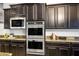 Gourmet kitchen featuring stainless steel appliances and dark cabinetry for a sleek, modern look at 2862 Athens Ridge Dr, Henderson, NV 89052