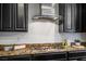 Modern kitchen featuring granite counters, stylish gas range, and black wood cabinets for a contemporary look at 2862 Athens Ridge Dr, Henderson, NV 89052