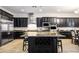 Elegant kitchen featuring dark cabinetry, granite countertops, stainless steel appliances and center island at 2862 Athens Ridge Dr, Henderson, NV 89052