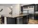Open-concept kitchen boasts a large island, stainless steel appliances, and sleek cabinetry, perfect for entertaining at 2862 Athens Ridge Dr, Henderson, NV 89052