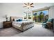 Serene main bedroom with plush carpeting, balcony access, and generous natural light at 2862 Athens Ridge Dr, Henderson, NV 89052
