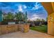Outdoor kitchen and entertainment space featuring a built-in grill and putting green at 2862 Athens Ridge Dr, Henderson, NV 89052