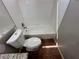 A bathroom featuring a toilet and tub with white tile surround at 316 Lingering Ln, Henderson, NV 89012