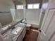 Bathroom with granite countertop, tub, and red tile floors at 316 Lingering Ln, Henderson, NV 89012