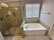A soaking tub is adjacent to the glass-enclosed shower in this bathroom at 316 Lingering Ln, Henderson, NV 89012