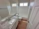Bathroom with granite countertop, white cabinets and tile floor at 316 Lingering Ln, Henderson, NV 89012