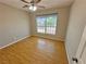 A well-lit bedroom featuring a large window and laminate wood flooring at 316 Lingering Ln, Henderson, NV 89012