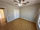 Bedroom featuring wood-look floors, a ceiling fan and double door closet at 316 Lingering Ln, Henderson, NV 89012