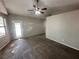 A carpeted bedroom with a ceiling fan and a door leading outside at 316 Lingering Ln, Henderson, NV 89012
