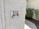 Close-up of house number on textured exterior wall at 316 Lingering Ln, Henderson, NV 89012