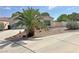 Single-story home with a xeriscaped front yard, featuring a young palm tree at 316 Lingering Ln, Henderson, NV 89012