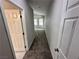 Hallway with gray carpet and a view into a room with backyard window and natural light at 316 Lingering Ln, Henderson, NV 89012
