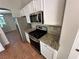 Modern kitchen appliances including a stainless steel refrigerator, microwave, and gas range at 316 Lingering Ln, Henderson, NV 89012
