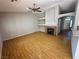 Inviting living room featuring hardwood floors, a fireplace, and built-in shelving at 316 Lingering Ln, Henderson, NV 89012
