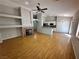 Open-concept living room with hardwood floors, a fireplace, and a view into the kitchen at 316 Lingering Ln, Henderson, NV 89012