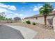 An empty backyard featuring a small palm tree and rock landscaping at 3228 Jumping Hills Ave, Henderson, NV 89052