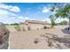Backyard with a patio and rock landscaping surrounded by a block wall at 3228 Jumping Hills Ave, Henderson, NV 89052