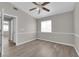 Bedroom with hardwood flooring, neutral color scheme, ceiling fan, and natural light at 3228 Jumping Hills Ave, Henderson, NV 89052
