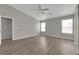Spacious bedroom with neutral paint, wood-look floors, ceiling fan, and lots of natural light at 3228 Jumping Hills Ave, Henderson, NV 89052
