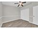 Cozy bedroom featuring wood floors, neutral paint, ceiling fan, and sliding door closet at 3228 Jumping Hills Ave, Henderson, NV 89052