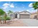 Inviting one-story home with a well-maintained front yard and a spacious two-car garage at 3228 Jumping Hills Ave, Henderson, NV 89052