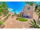 Spacious backyard featuring an easy-care landscape design with gravel, small plants, and a touch of green turf at 3425 Bedfordshire Pl, Las Vegas, NV 89129