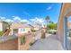 Relaxing view from the balcony with wrought iron railing showcasing neighboring houses and desert landscaping under a clear sky at 3425 Bedfordshire Pl, Las Vegas, NV 89129