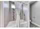 Bright bathroom featuring a tiled shower and tub combination with a shower curtain, offering a clean and functional space at 3425 Bedfordshire Pl, Las Vegas, NV 89129