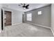 Spacious bedroom boasts plush carpeting, neutral walls, modern ceiling fan, and bright window with ample natural light at 3425 Bedfordshire Pl, Las Vegas, NV 89129