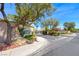 Cambridge Crossing residential entrance with lush landscaping, mature trees, and attractive stone signage at 3425 Bedfordshire Pl, Las Vegas, NV 89129