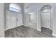 Bright foyer with soaring ceilings, gray wood-look tile flooring, and a large arched window above the double front doors at 3425 Bedfordshire Pl, Las Vegas, NV 89129