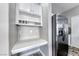 Built-in desk and storage in the kitchen featuring stylish white cabinets and stone look flooring at 3425 Bedfordshire Pl, Las Vegas, NV 89129