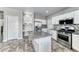 Open kitchen with stainless steel appliances, an island, and stone look tile flooring at 3425 Bedfordshire Pl, Las Vegas, NV 89129