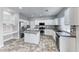 Modern kitchen with white cabinets, granite countertops, stainless steel appliances, and a tile backsplash at 3425 Bedfordshire Pl, Las Vegas, NV 89129