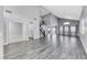 Spacious living room boasting high ceilings, gray wood-look flooring, a staircase, and ample natural light at 3425 Bedfordshire Pl, Las Vegas, NV 89129