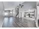Open concept living area with high ceilings, wood-look floors, a staircase, and a view of the modern kitchen at 3425 Bedfordshire Pl, Las Vegas, NV 89129