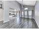 Bright and airy living space featuring high ceilings, wood-look floors, and a view of the modern kitchen at 3425 Bedfordshire Pl, Las Vegas, NV 89129