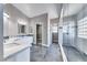 Modern main bathroom with dual sinks, a walk-in shower, and tile flooring at 3425 Bedfordshire Pl, Las Vegas, NV 89129