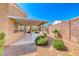 Backyard featuring covered patio and desert landscaping, providing a private retreat for relaxation and outdoor activities at 3425 Bedfordshire Pl, Las Vegas, NV 89129