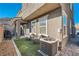 Charming backyard patio with outdoor seating area, a grass patch and a small brick privacy wall at 377 Yellow Finch Ln, Henderson, NV 89012