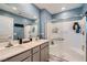 Stylish bathroom with double vanity, modern fixtures, and a glass-enclosed shower, offering a luxurious experience at 377 Yellow Finch Ln, Henderson, NV 89012