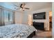 Comfortable bedroom featuring a ceiling fan, closet, and TV; designed for relaxation and restful nights at 377 Yellow Finch Ln, Henderson, NV 89012