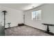 Neutral bedroom with a window, gray carpet, and minimal furnishings at 377 Yellow Finch Ln, Henderson, NV 89012